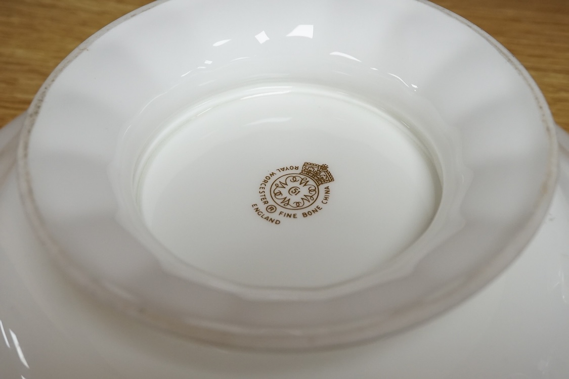 Three pieces of Worcester comprising a fruit printed and painted dish, bears signature Freeman, floral jug and a miniature tyg hand painted with a bird, largest 24cm in diameter